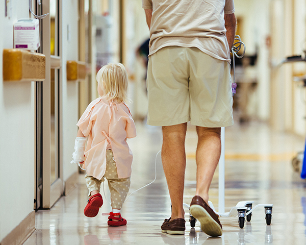 Photo of child and father in hospital. 